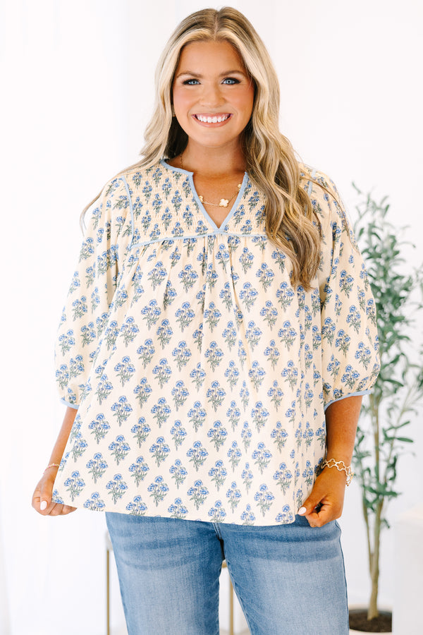 Plus Size cream floral cotton top with blue piping, smocked chest, and three-quarter sleeves.