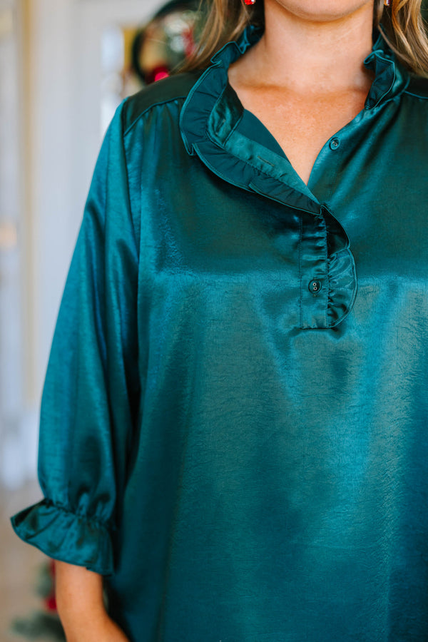 Plus size emerald satin top with a ruffled neckline, functional buttons, and elastic puff sleeves.