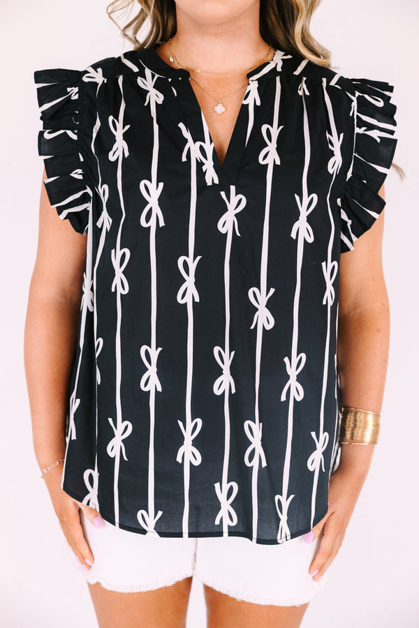 Chic soul plus size clothing, black top with flutter sleeves and a v-neckline as well as a white bow striped pattern throughout

