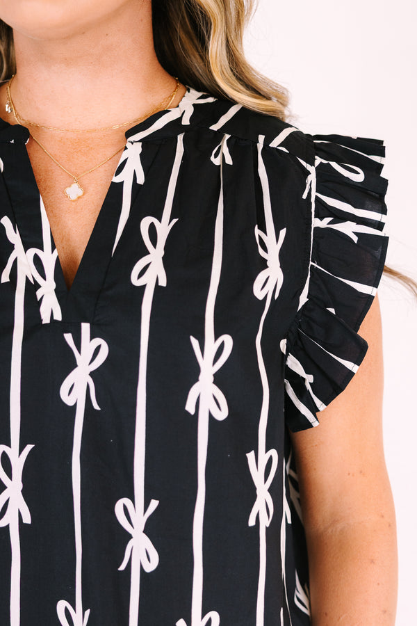 Chic soul plus size clothing, black top with flutter sleeves and a v-neckline as well as a white bow striped pattern throughout
