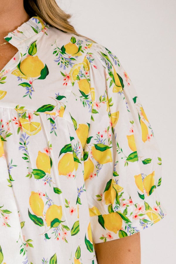 Chic Soul plus size clothing, white short sleeve top with yellow lemon print design through the top, v-neckline, and slight ruffle collar
