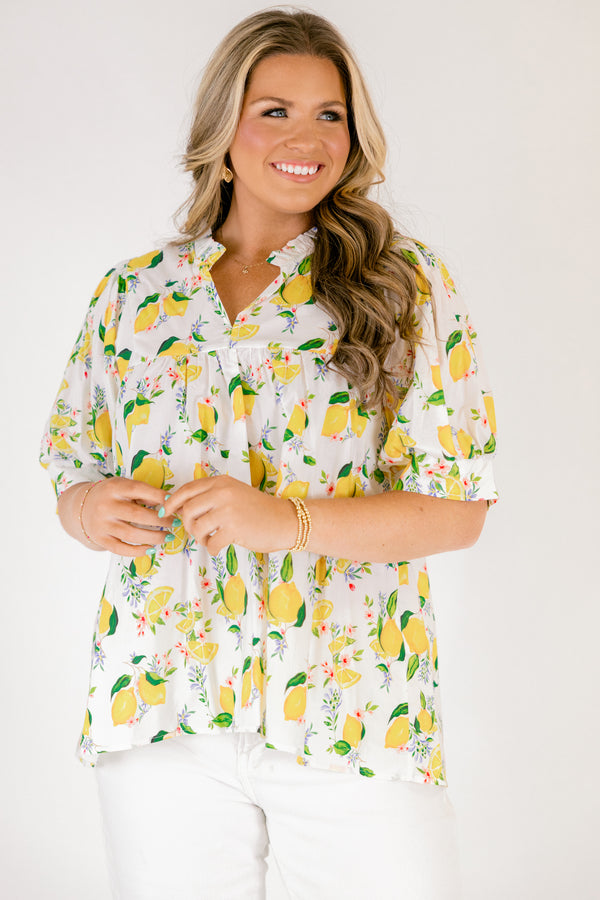 Chic Soul plus size clothing, white short sleeve top with yellow lemon print design through the top, v-neckline, and slight ruffle collar