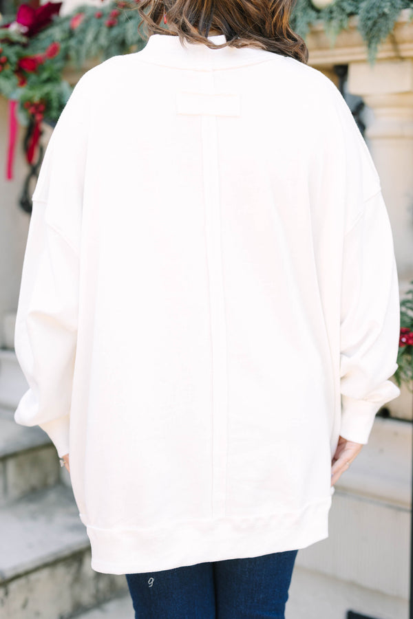 Plus Size ivory mock neck pullover with a graphic 
