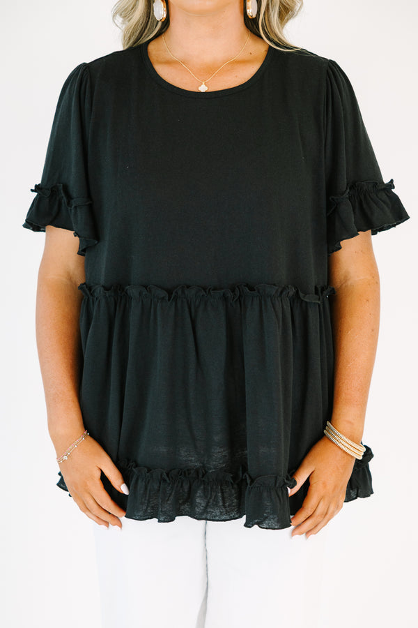 Plus Size black babydoll top with ruffled short sleeves and a tiered, ruffled hemline.