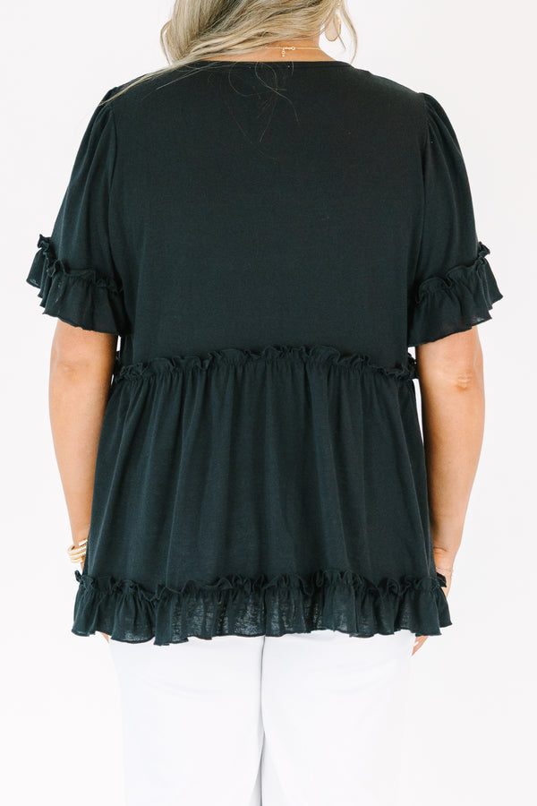 Plus Size black babydoll top with ruffled short sleeves and a tiered, ruffled hemline.