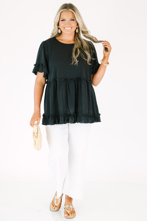 Plus Size black babydoll top with ruffled short sleeves and a tiered, ruffled hemline.