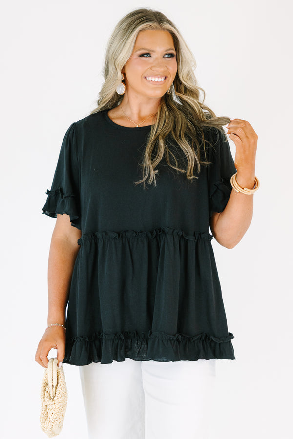 Plus Size black babydoll top with ruffled short sleeves and a tiered, ruffled hemline.