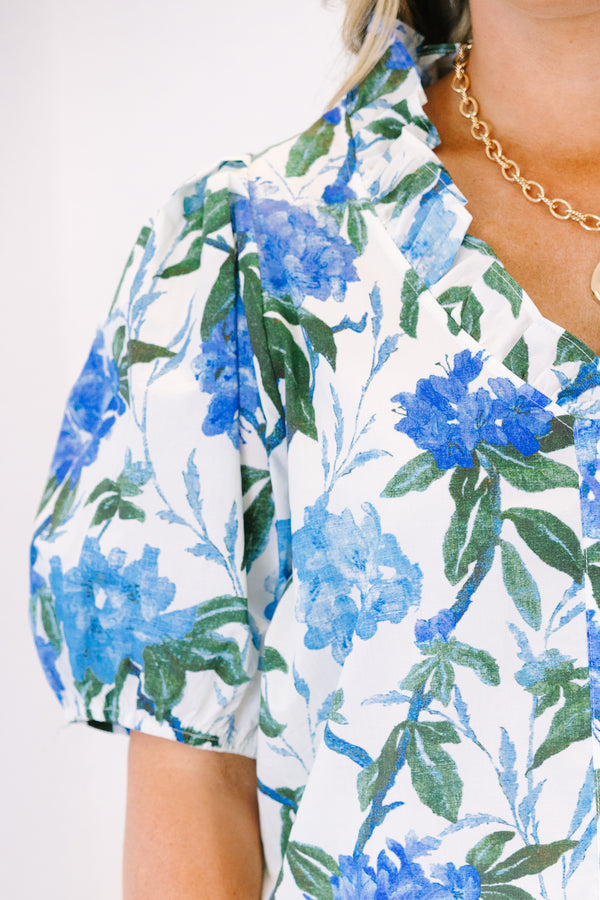 Plus Size ivory button-up top with blue floral print, ruffled collar, and puff sleeves.