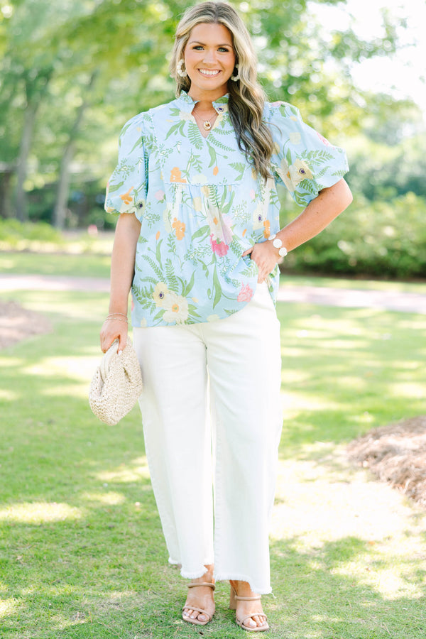 Plus Size light blue floral babydoll top with puff sleeves, a ruffled neckline, and a v-cutout.