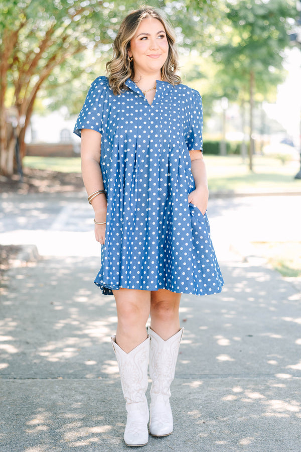 Plus Size navy blue short sleeve dress with white polka dots and a split v-neckline.