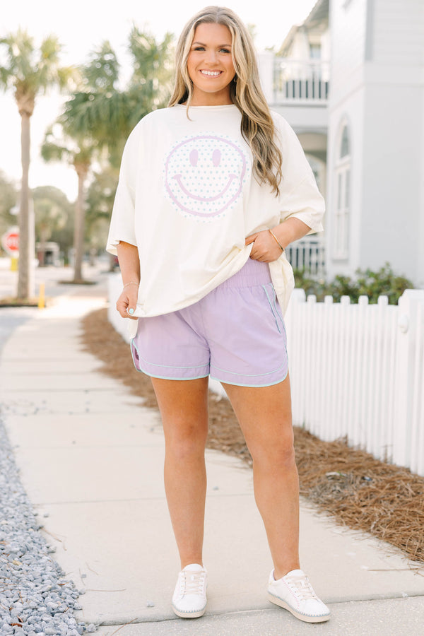 Chic Soul plus size clothing, white short sleeve boyfriend tee with light purple smiley face on white circle background on the front of the tee with light blue polka dots inside of the smiley face