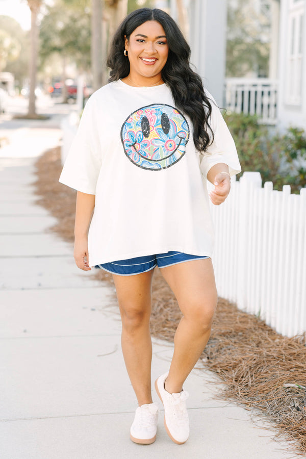 Chic Soul plus size clothing, ivory white short sleeve boyfriend tee with black outline of smiley face on the front and retro colorful flower pattern inside smiley face