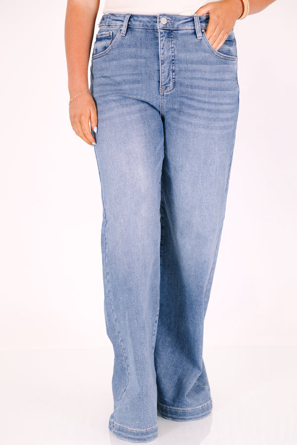 High-rise, wide-leg jeans in a medium wash with a multi-snap waistband and tummy control.