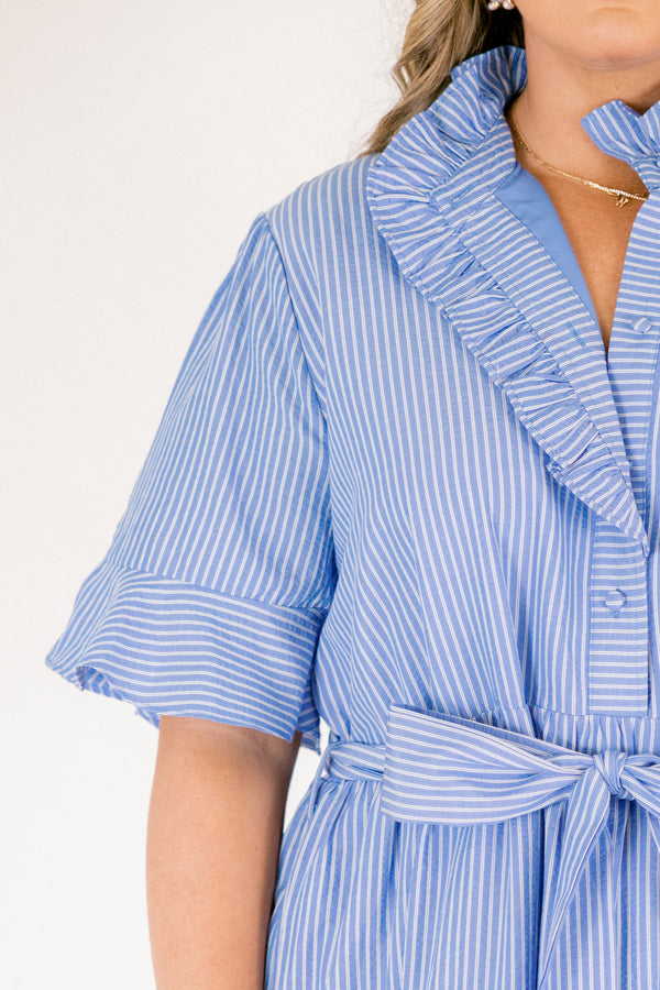 Chic Soul plus size clothing, blue striped tiered midi dress with short sleeves that have a ruffle at the end of them as well as a ruffle detail going around the collar and down the buttons on the chest and a belt that ties into a bow that goes around the waist