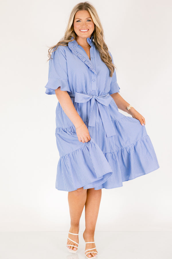 Chic Soul plus size clothing, blue striped tiered midi dress with short sleeves that have a ruffle at the end of them as well as a ruffle detail going around the collar and down the buttons on the chest and a belt that ties into a bow that goes around the waist