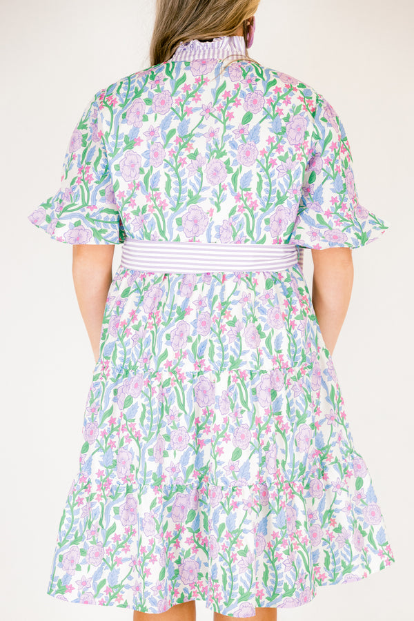 Chic Soul plus size clothing, purple floral midi dress with short sleeves that have a ruffle detail at the bottom of each sleeves as well as a striped purple pattern going down the chest and along the neckline as well as a striped belt that ties around the waist 