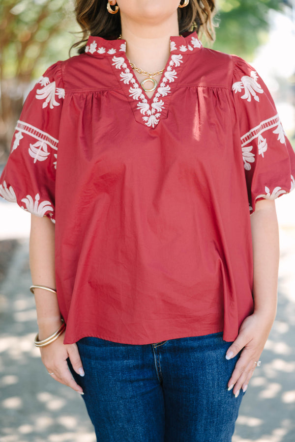 Plus size crimson cotton top with white embroidery, V-neckline, and flowy puff sleeves.