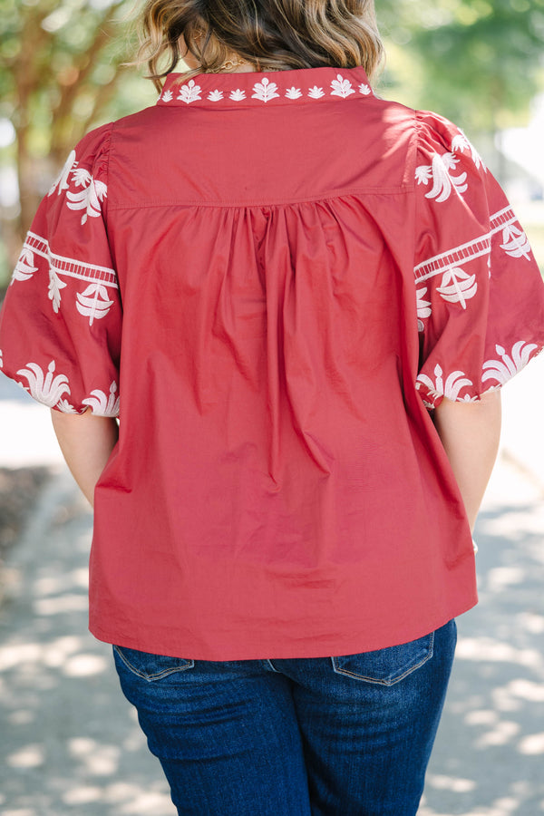 Plus size crimson cotton top with white embroidery, V-neckline, and flowy puff sleeves.