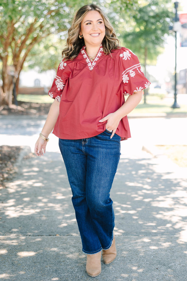 Plus size crimson cotton top with white embroidery, V-neckline, and flowy puff sleeves.
