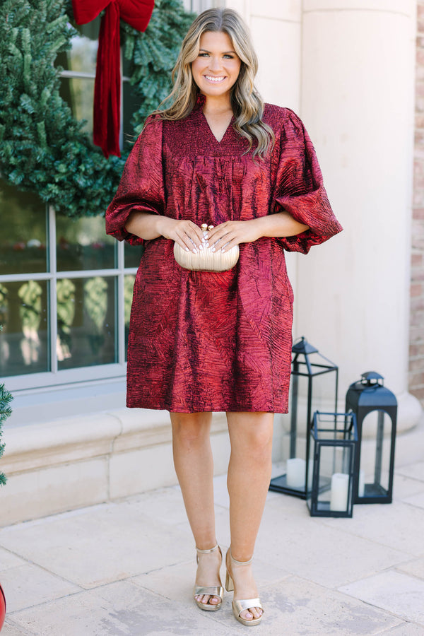 Plus Size red textured metallic dress with a smocked yoke, V-neckline, and puff sleeves.