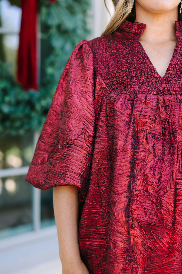 Plus Size red textured metallic dress with a smocked yoke, V-neckline, and puff sleeves.