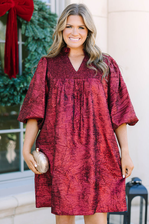 Plus Size red textured metallic dress with a smocked yoke, V-neckline, and puff sleeves.