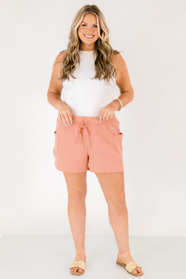 Chic Soul plus size clothing, rose colored lien shorts with pocket on the side of each short leg and a draw string waistband that has a bow that ties in the middle of the shorts 