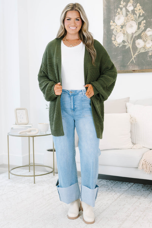 Plus size light wash high-rise wide-leg jeans featuring oversized cuffed hems and patch pockets.