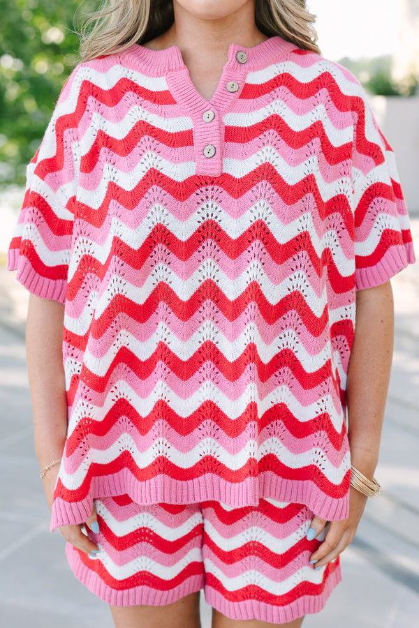Chic soul plus size clothing, pink and red woven short set with a short sleeve top and both have a red and pink woven wavey pattern as well as the top having a button -up neckline 