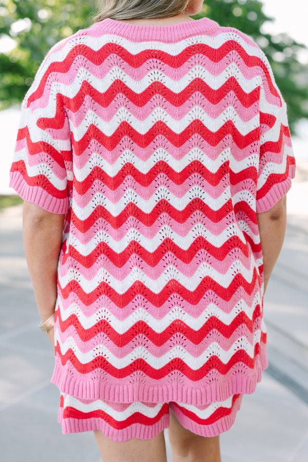 Chic soul plus size clothing, pink and red woven short set with a short sleeve top and both have a red and pink woven wavey pattern as well as the top having a button -up neckline 