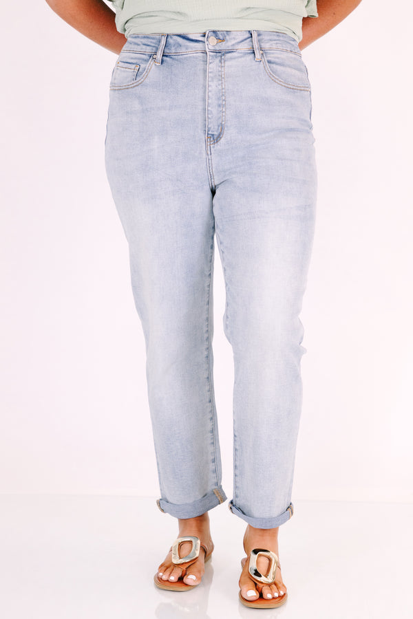Plus Size high-rise, light wash straight-leg jeans with cuffed hems.
