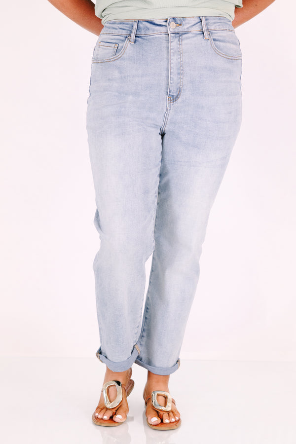 Plus Size high-rise, light wash straight-leg jeans with cuffed hems.