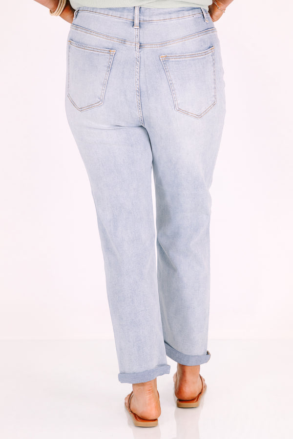 Plus Size high-rise, light wash straight-leg jeans with cuffed hems.