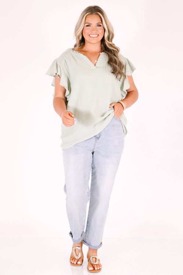 Plus Size high-rise, light wash straight-leg jeans with cuffed hems.