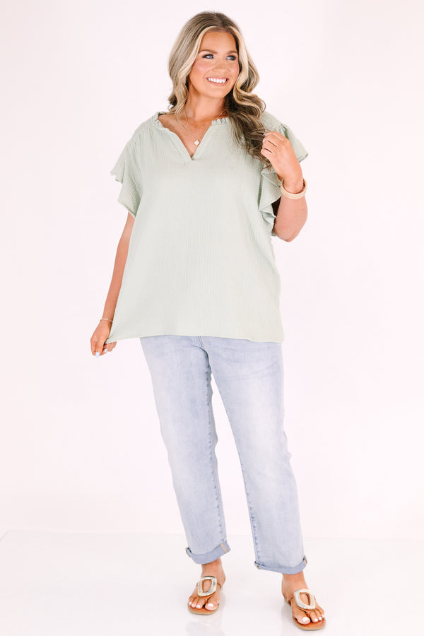 Plus Size high-rise, light wash straight-leg jeans with cuffed hems.