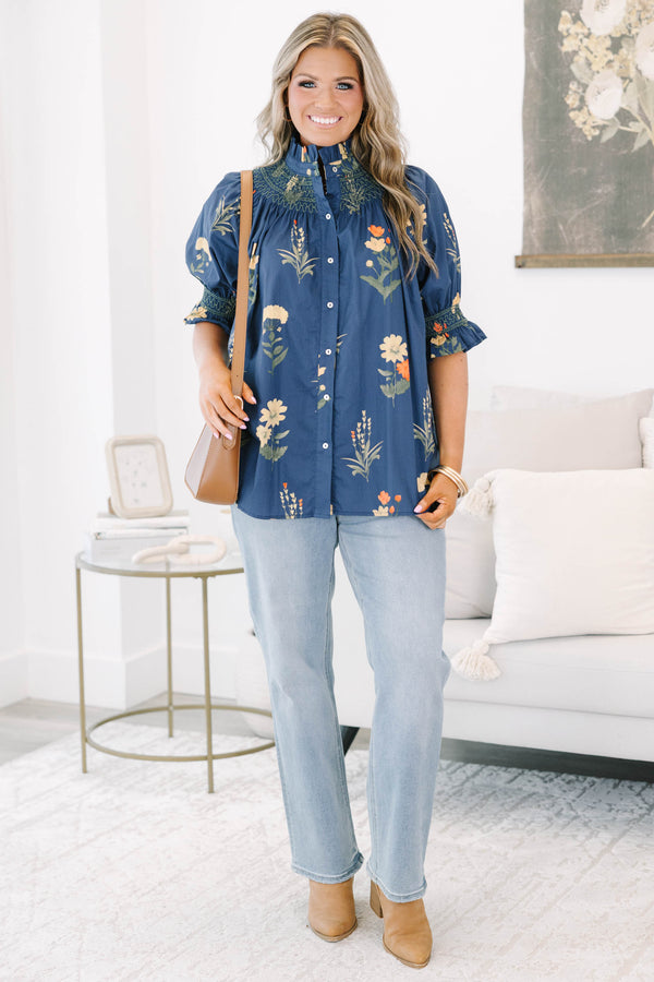 Plus size navy floral cotton top with smocked high neck, button front, and flowy puff sleeves.