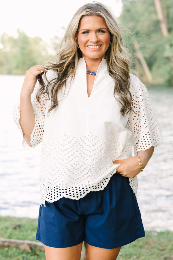Plus Size white eyelet top with a split neckline, flutter sleeves, and a scalloped hemline.