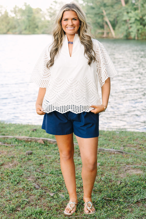 Plus Size white eyelet top with a split neckline, flutter sleeves, and a scalloped hemline.