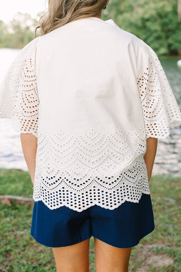 Plus Size white eyelet top with a split neckline, flutter sleeves, and a scalloped hemline.