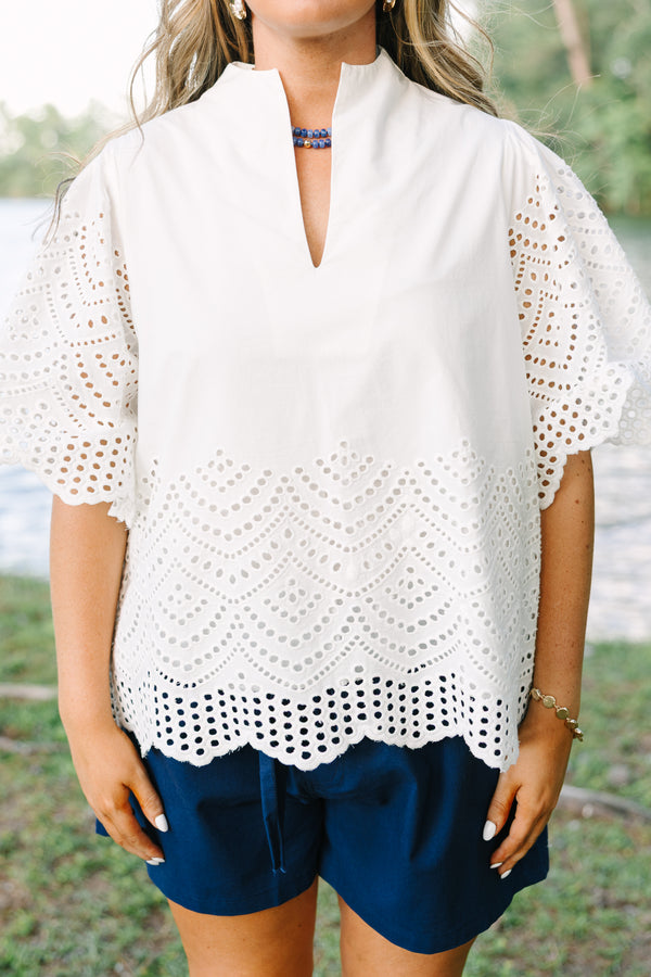 Plus Size white eyelet top with a split neckline, flutter sleeves, and a scalloped hemline.