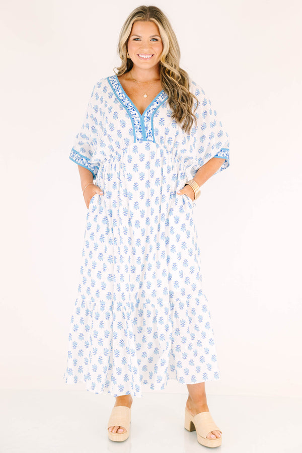 Chic Soul plus size clothing, cerulean blue maxi dress with short sleeves that have a floral pattern cuffed as well as a floral pattern outlining the v-neckline and a floral block pattern throughout