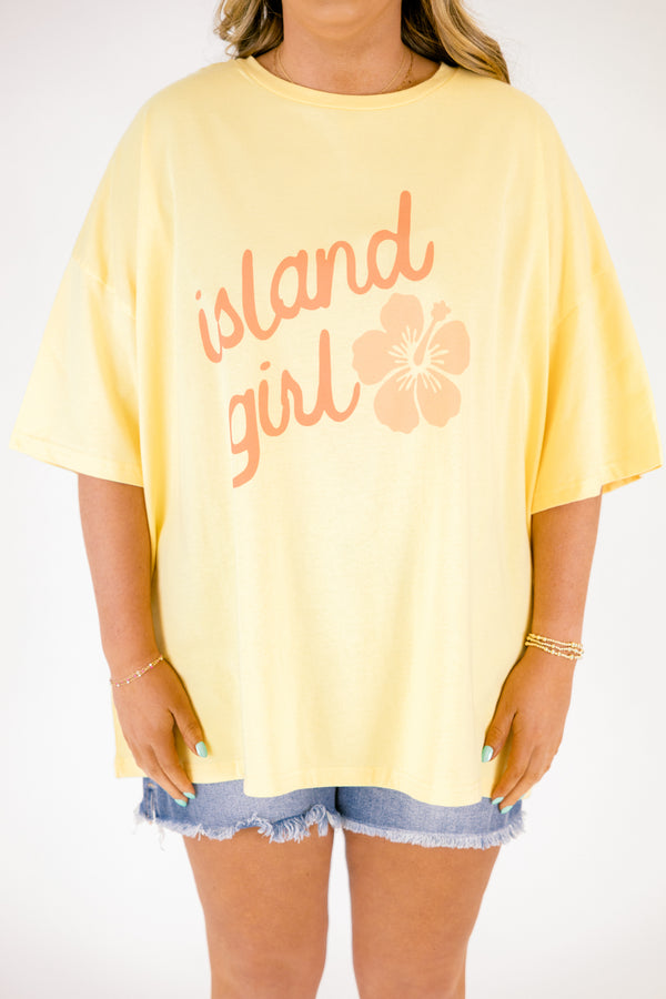 Chic Soul plus size clothing, butter yellow short sleeve oversized tee with “island girl” text in script font with a flower off to the side