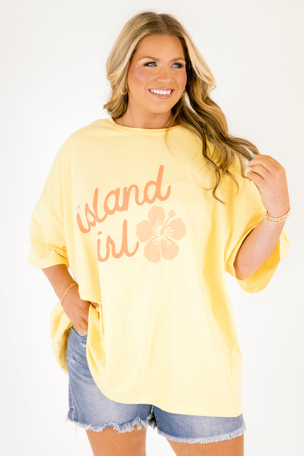 Chic Soul plus size clothing, butter yellow short sleeve oversized tee with “island girl” text in script font with a flower off to the side