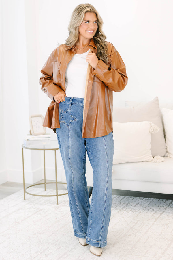Plus Size medium wash wide leg jeans with star-shaped stitching on the front pockets and seams.