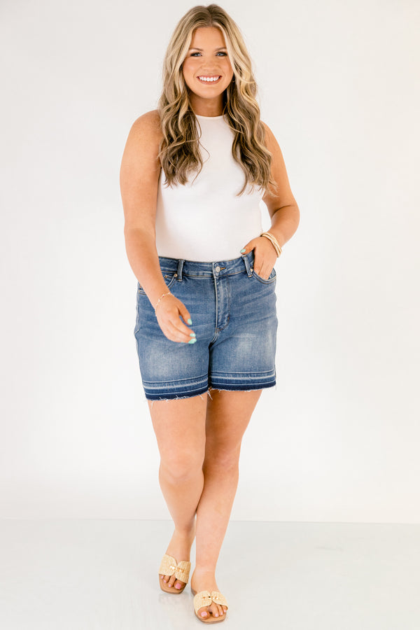 Chic Soul plus size clothing, dark washed jean shorts with front pockets and a distressed look as well as fringe details on the bottom of each short leg