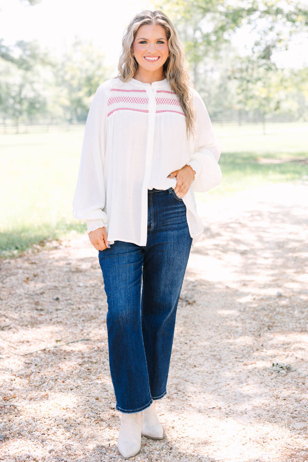 Plus Size cream long-sleeved top with red smocked embroidery on the chest and smocked cuffs.