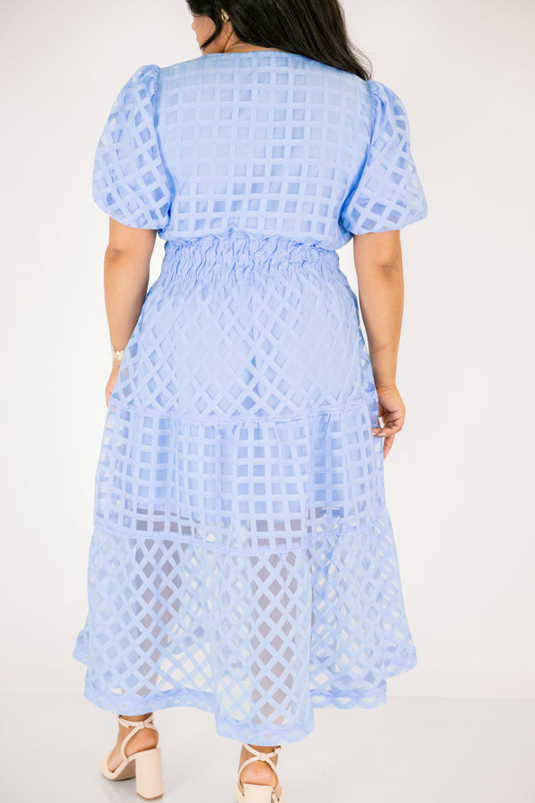 Chic Soul plus size clothing, pastel blue maxi dress with buttons going down to the chest and bubble sleeves as well as a sheer overlay going over the whole dress that has a plaid pattern 