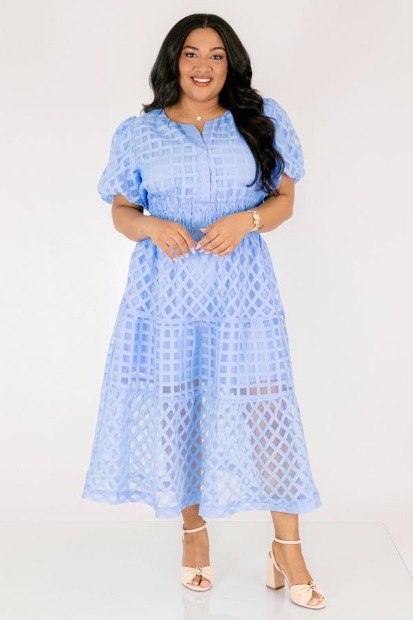 Chic Soul plus size clothing, pastel blue maxi dress with buttons going down to the chest and bubble sleeves as well as a sheer overlay going over the whole dress that has a plaid pattern 