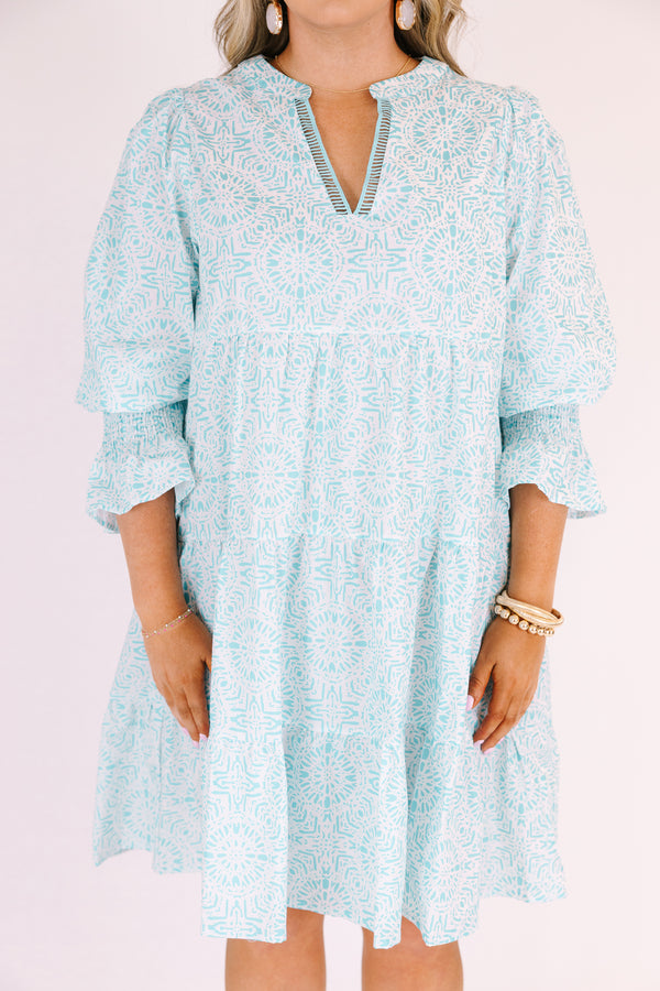 Chic Soul plus size clothing, teal knee length dress with half sleeves that have a ruffle flare out on the ends as well as a v-neckline circle abstract pattern throughout 
