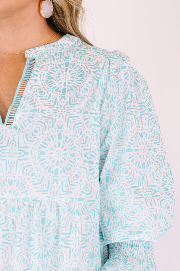 Chic Soul plus size clothing, teal knee length dress with half sleeves that have a ruffle flare out on the ends as well as a v-neckline circle abstract pattern throughout 
